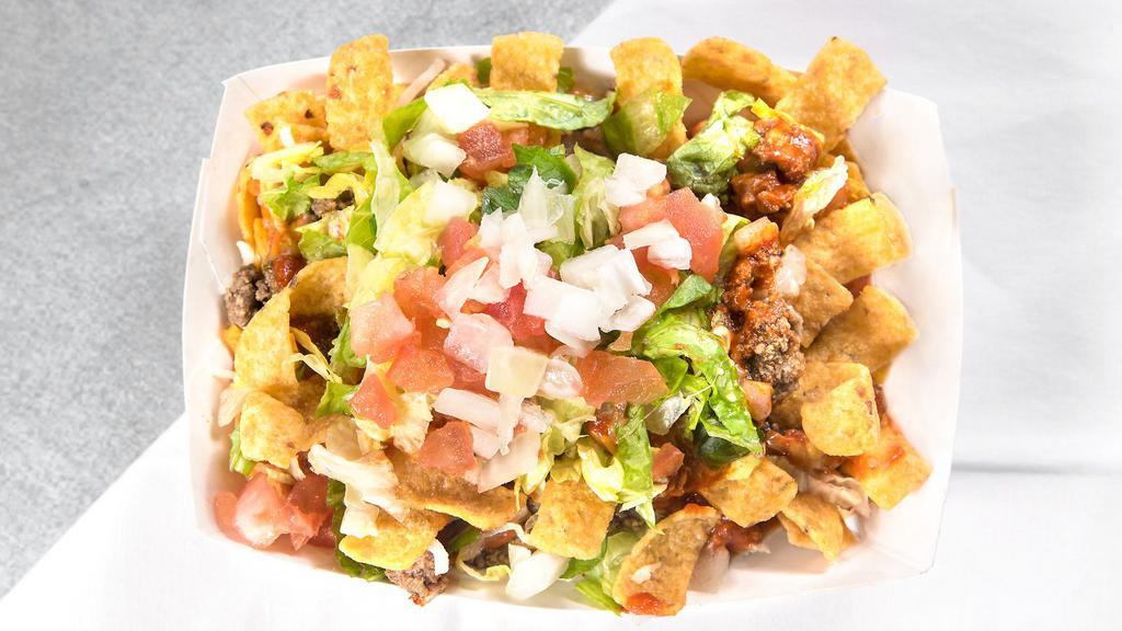 Frito Pie · Fritos corn chips topped with house made pinto beans, Cheese, ground beef, and our own Red Chile sauce. Lettuce, Onions and Tomatoes.