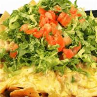 Nacho Mama · House made tortilla chips layered with shredded cheese, pinto beans, and Chile con Queso, to...