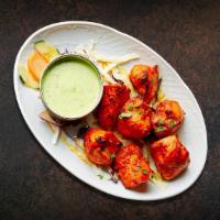 Smoked Chicken Tikka · Boneless pieces of chicken marinated and barbecued in a tandoor clay oven.