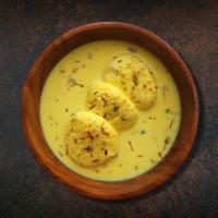 Divine Rasmalai · Cottage cheese patties flattened and soaked in milk with whole spices.