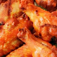 Grilled Chicken Wings · (GF) 8 Grilled Chicken Wings tossed in hot sauce & served with Toum.