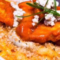 Wingin' It Mac And Cheese · Sharp cheddar mac with Buffalo sauce topped with fried Buffalo chicken, blue cheese, scallio...