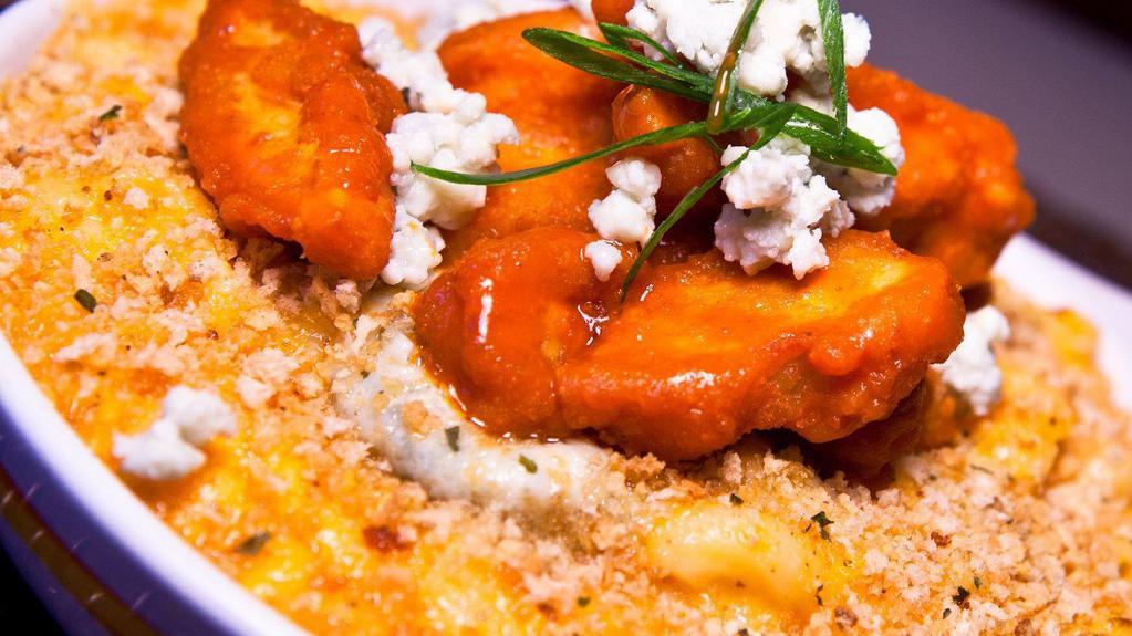 Wingin' It Mac And Cheese · Sharp cheddar mac with Buffalo sauce topped with fried Buffalo chicken, blue cheese, scallions and Buffalo ranch.