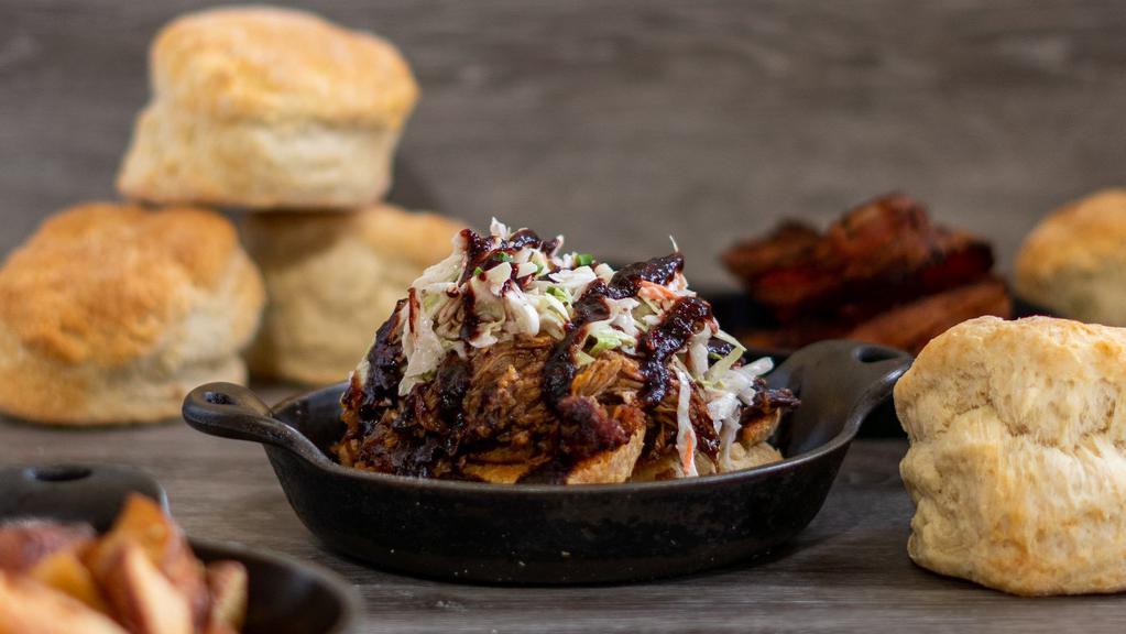 Pulled Pork On A Biscuit · With Blackberry Ancho BBQ Sauce and Coleslaw