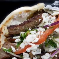 Super Gyro · Choice of lamb or chicken, served on Greek pita with house tzatziki, ﬁnished with tomato, on...