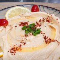 Hummus Plate · Garbanzo beans mashed with garlic, fresh lemon juice, and tahini sauce. Served with pita bre...
