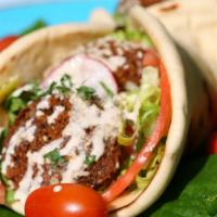 Super Falafel · Delicious, golden falafel balls quickly deep fried. wrapped in a Greek pita with hummus, tah...