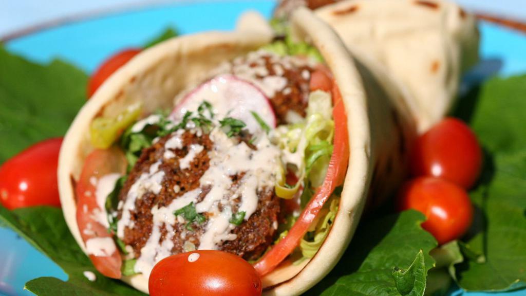 Super Falafel · Delicious, golden falafel balls quickly deep fried. wrapped in a Greek pita with hummus, tahini sauce, lettuce, and tomato. Large pita, more falafel and comes with feta cheese.