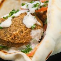 Falafel Sandwich · Delicious, golden falafel balls quickly deep fried and wrapped in a Greek pita with hummus, ...