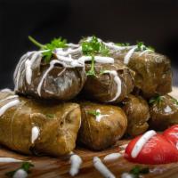 Dolmades · Six pieces. Grape leaves stuffed with rice and herbs. (V) Served cold with tzatziki sauce.