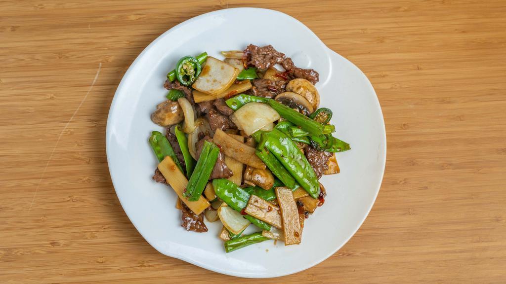 Mongolian Beef Army · Sliced beef stir-fried with white and green onions in a Mongolian sauce over a bed of crisp rice noodles