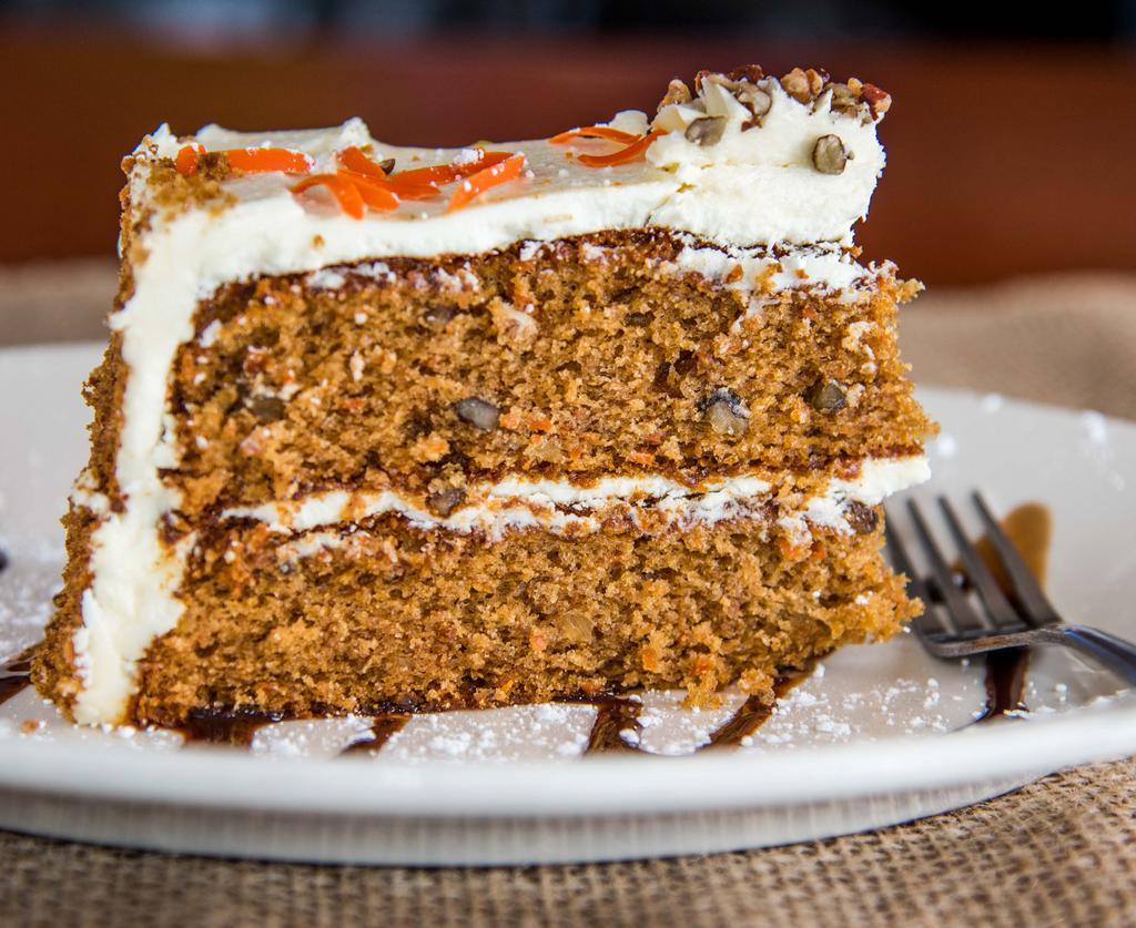 Carrot Cake · Three layers of rich carrot cake with cream cheese frosting, served warm.