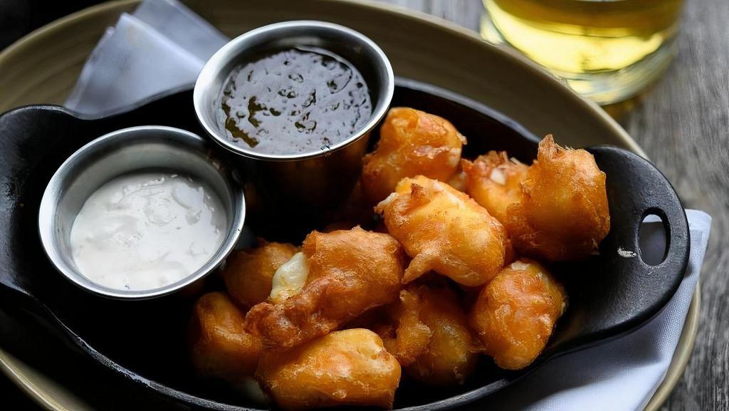 Wisconsin Cheese Curds · Beer battered cheese curds, jalapeño jelly, peppercorn sauce.. We charge 20% more for items on ALL third party delivery sites to cover the commission they charge us.  If you want to avoid this premium, we invite you to order for delivery or take-out .  at www.tavern-hall.com.