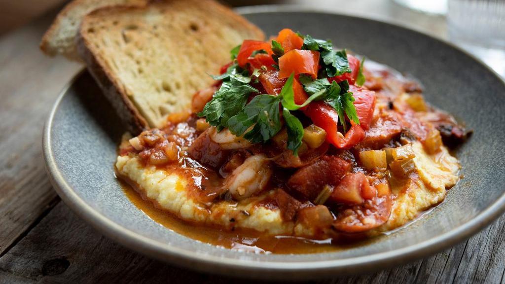 Shrimp & Grits · Creole sauce, Andouille sausage, white cheddar grits, Mama Lil's peppers, toasted como bread.