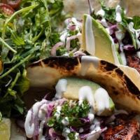 Fish Tacos · Grilled ancho chile-glazed Columbia River steelhead, kale slaw, avocado, lime crema, flour t...