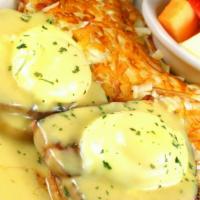 Eggs Benedict · English muffin topped with grilled pit ham, two topped eggs and smothered with hollandaise s...