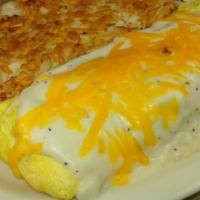 Chicken Fried Steak Omelette · Our famous chicken fried steak chopped up and tucked into a omelette with country gravy and ...