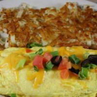 Taco Omelette · Seasoned ground beef and cheese, topped with green onions, black olives and tomatoes. Served...