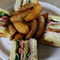 Triple Decker Club House · Stacked on three slices of our homemade bread, sliced ham, Turkey, bacon, fresh lettuce, tom...
