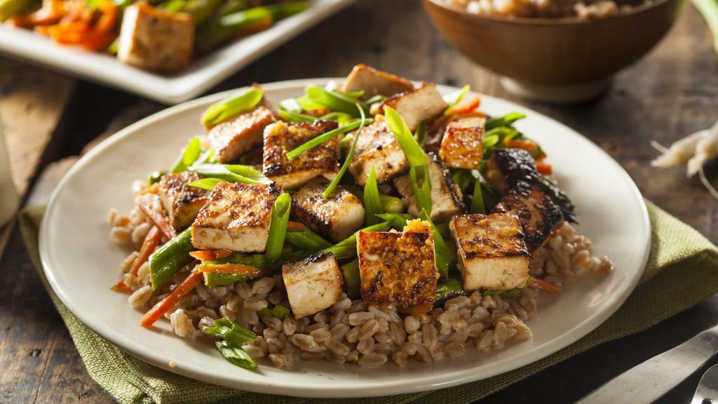 Chinese Tofu Fried Rice · Chinese fried rice with tofu, mixed vegetables, eggs, and onions.