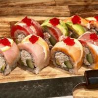 Rainbow Roll · Crab mix, cucumber, avocado, topped with assortment of fish, lemon slices and tobiko.