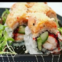 Flaming Dragon Roll · Ebi shrimp, cucumber, avocado, tobiko inside topped with  spicy tuna, crunchies and poki sau...