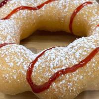 Raspberry Funnel Cake · Raspberry drizzle and dusted with powdered sugar.