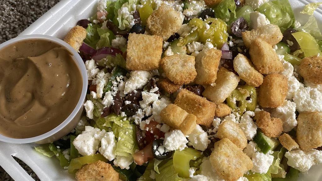 Greek Salad · Romaine lettuce, tomato, cucumbers, onion, feta cheese, kalamata olives, pepperoncini, croutons