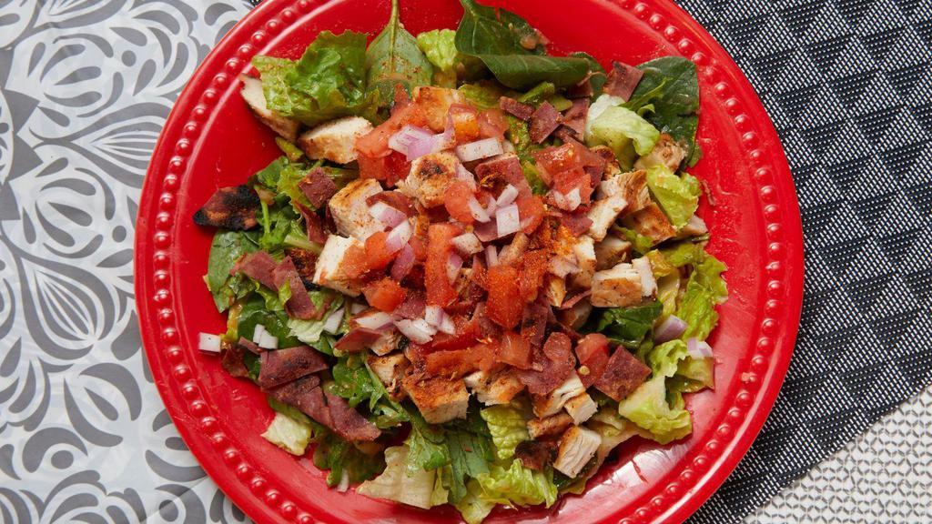 Mardi Gras Salad · Cajun seasoned chicken breast with turkey bacon, tomatoes, red onions and low carb salsetta dressing on a power blend of romaine, spinach and baby kale. (GF)