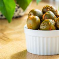 Olives (3 Oz.) · Our Castlevletrano Olives Marinated in Aleppo Chili and Fennel. They Still Have Their Pits
