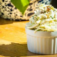Fennel & Min Coleslaw (3 Oz.) · Green Cabbage, Pickled Raisins, MInt, Creamy Slaw Dressing and a hint of Fennel