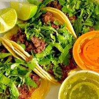 Tacos (4) · Onions, cilantro, lime wedges and side of salsas (red spicy and green mild).