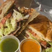 Tortas · Mexican Sandwich with a choice of meat garnish with lettuce, tomato, onion, avocado, pickle ...