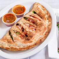 The Greek Calzone · The greek calzone is served with feta, greek olives, gyro meat, onions, pizza sauce, tzatzik...