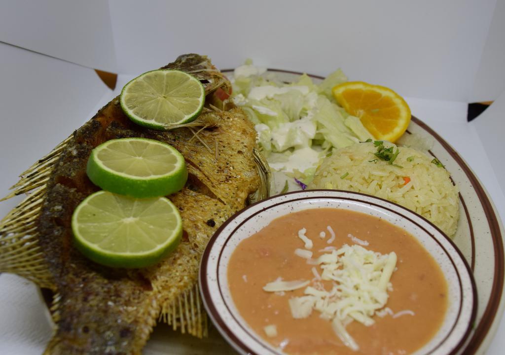 Mojarra Frita · Fried fish with rice, beans and salad.