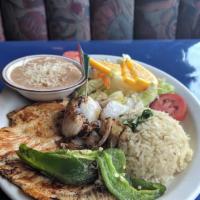 Pollo À La Plancha · Grilled chicken with rice, beans and avocado slices.