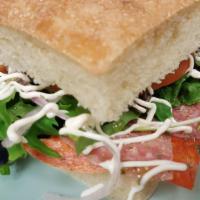 Italian Sandwich · Provolone cheese, pepperoni, salami, spring mix, tomato, onion, oregano, olive oil, mayo.