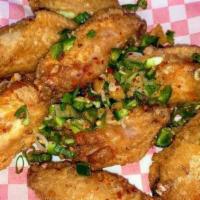 Chicken Wings / Canh Ga Chien · Eight deep fried chicken wings. Choose between BBQ, Buffalo, Salt & Pepper (pictured), or pl...