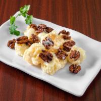 Honey Walnut Prawns · Crispy battered prawns tossed in a creamy sauce topped with sugar coated walnuts.