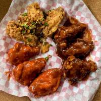 Chicken Wing Sampler / Canh Ga Chien Dac Biet · Deep fried wings tossed in BBQ, Buffalo, and Salt & Pepper all on one plate.