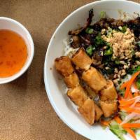 Grilled Bowl / Bun Thit Nuong · Rice noodle salad bowl with lettuce, cucumbers, bean sprouts, basil, topped with pickled dai...