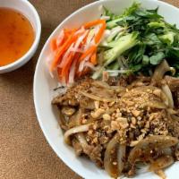 Lemongrass Bowl / Bun Xao Sa · Rice noodle salad bowl with lettuce, cucumbers, bean sprouts, basil, topped with pickled dai...
