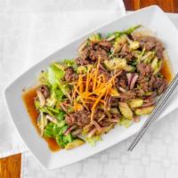 Yum Neua Salad · Sliced beef, cucumber and onions over greens lettuce with roasted chili lime dressing.