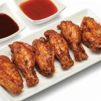 Bone-In Wings - 6 · Crispy and flavorful classic chicken wings with choice of 1 flavor-packed sauce.