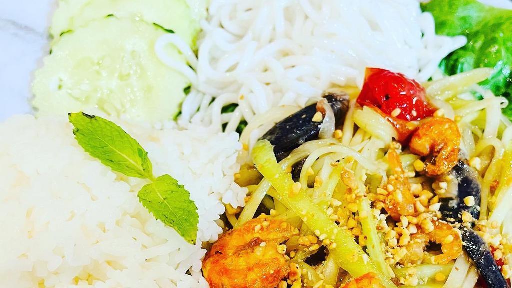 Cambodian Papaya Salad Platter · Spicy Papaya, Black Crab, Dried Shrimp, and Peanuts Served with White Rice.