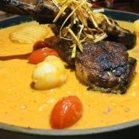 Lamb Massaman Curry · Spicy. Marinated Colorado rack of grilled lamb, fried potato, cherry tomatoes, peanuts, cris...