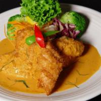 * Thai Catfish · Breaded and fried topped with Panang curry sauce, and finely sliced lime leave. Served with ...
