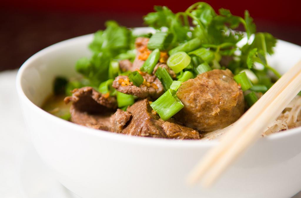 Thai Boat Noodle Soup · Traditionally sold from boats along the canals of Thailand, this dish features stewed beef, meatballs, rice noodles, bean sprouts and Chinese broccoli in a tasty homemade slow simmered beef broth flavored with herbs, spices and dry chili.