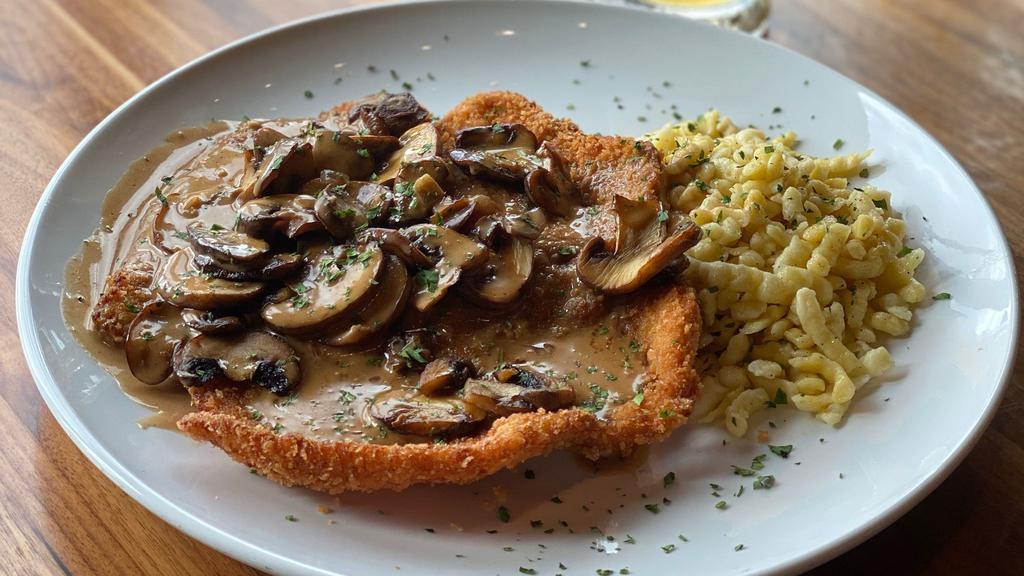 Chicken Jager Schnitzel · Tender breaded chicken topped with sauteed cremini mushrooms and Hungarian paprika sauce, on a bed of homemade spatzle or creamy mashed potatoes.