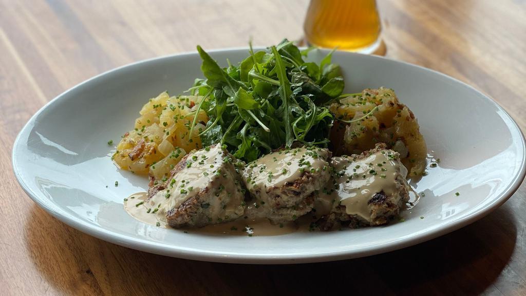 Bavarian Meatballs · Butter fried beef and pork meatballs, with spaten optimator cream sauce, house made German potato salad and fresh greens.